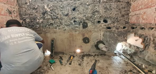 Concrete hacking and core drilling to form openings for new utility lines