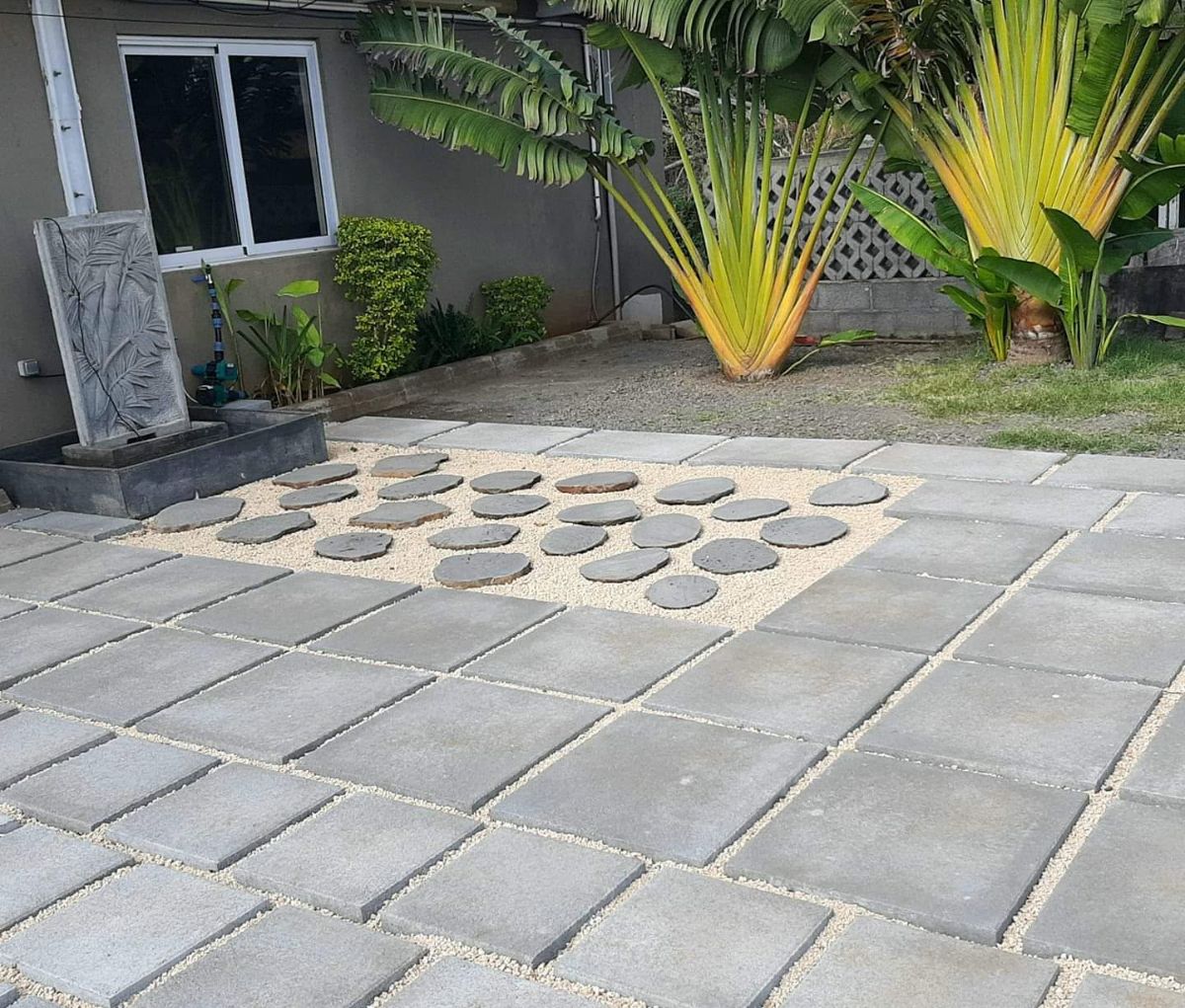 Paved courtyard with decorative stepping stones and gravel in Mauritius