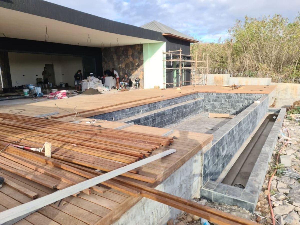 Custom timber decking built around a swimming pool in Mauritius